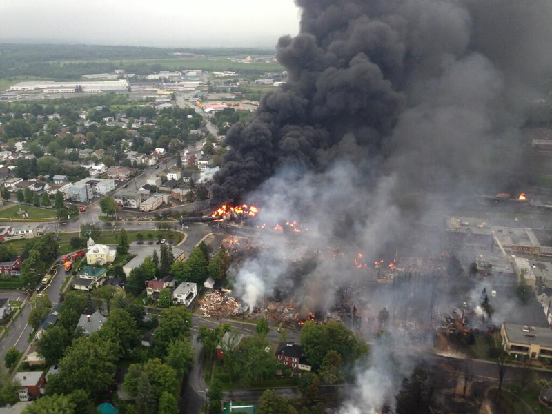 A view of Lac-Mégantic on the day of the derailment in 2013. A 74-car freight train carrying Bakken Formation crude oil rolled into the city's downtown. Multiple cars exploded, killing 37 people.